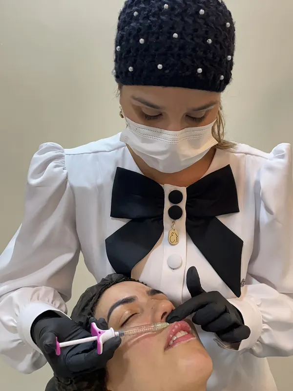 Dra. Érica Mello durante um procedimento de preenchimento labial